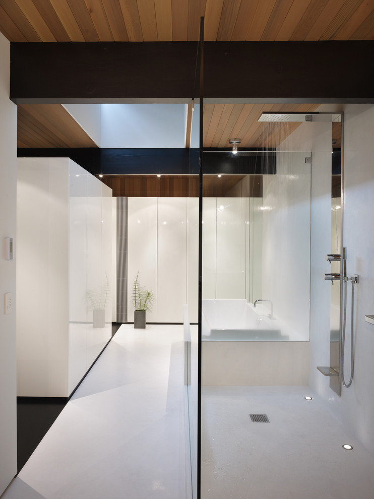 Design ideas for a mid-sized modern master bathroom in Seattle with flat-panel cabinets, white cabinets, a drop-in tub, an open shower, an undermount sink, white walls, an open shower and white floor.