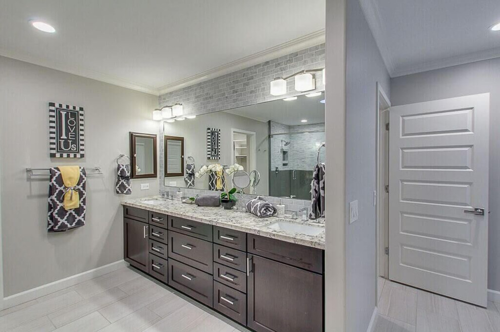 Example of a mid-sized transitional master ceramic tile doorless shower design in Phoenix with flat-panel cabinets, dark wood cabinets, a one-piece toilet, gray walls, a drop-in sink and granite countertops