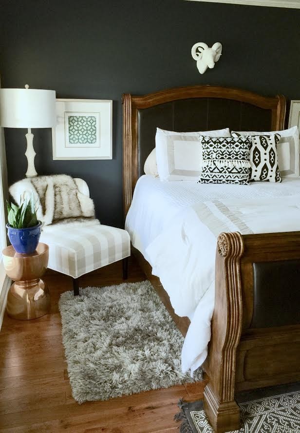 Inspiration for an eclectic master bedroom in Other with black walls and medium hardwood floors.