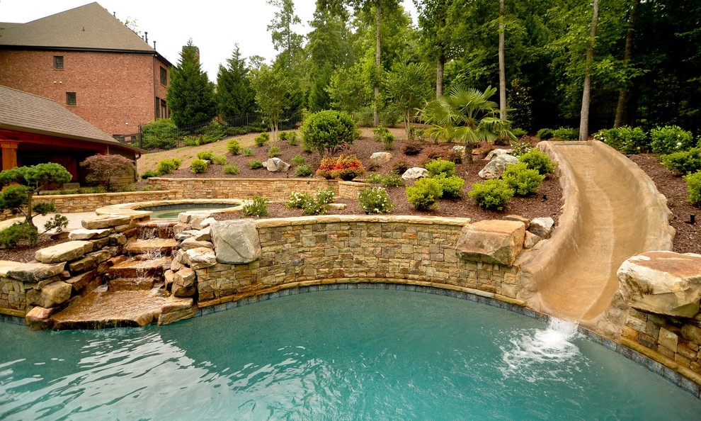 Photo of a traditional custom-shaped pool in Atlanta with a water slide.