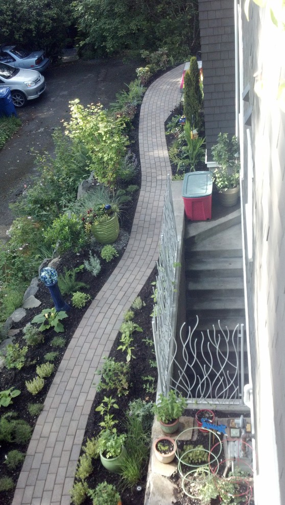 Photo of a small eclectic side yard full sun garden in Seattle with a vegetable garden and concrete pavers.
