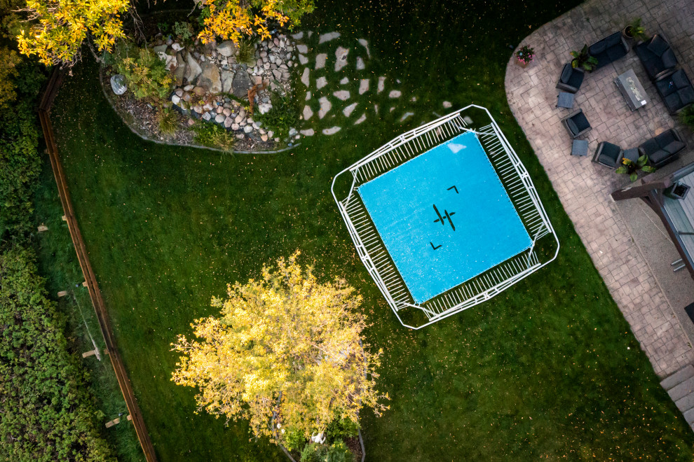 Inspiration for a large modern partial sun backyard outdoor basketball/tennis/multi-game court for summer.