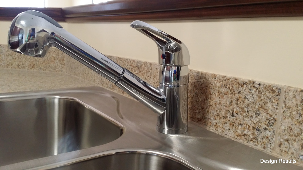 Example of a transitional kitchen design in Wilmington with a drop-in sink, beige backsplash, stone tile backsplash and stainless steel appliances