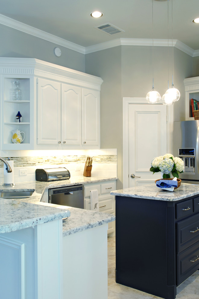 Inspiration for a large transitional u-shaped eat-in kitchen remodel in Dallas with white cabinets, granite countertops, multicolored backsplash, matchstick tile backsplash, stainless steel appliances and an island