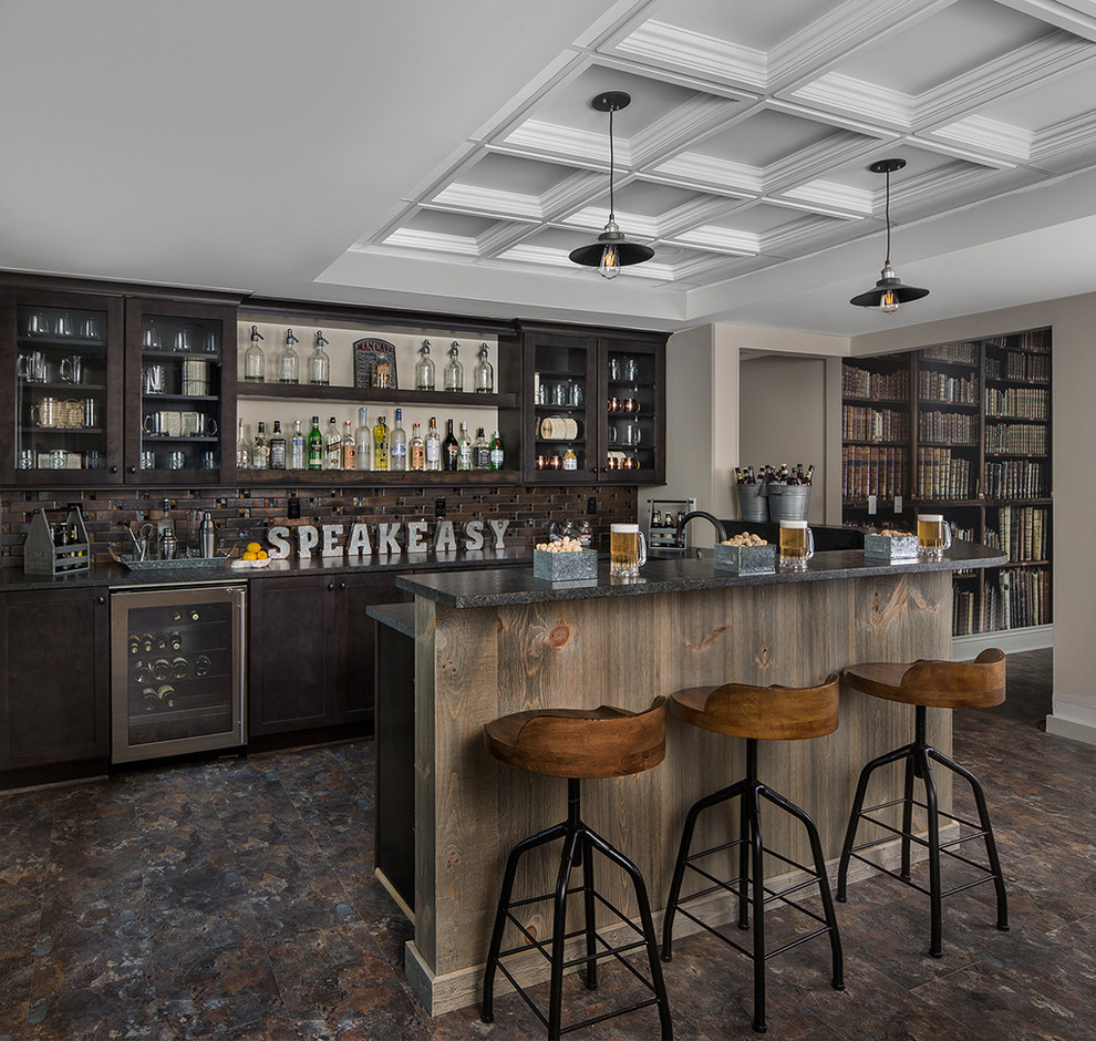 This is an example of a country u-shaped seated home bar in Detroit with glass-front cabinets, dark wood cabinets and brown splashback.