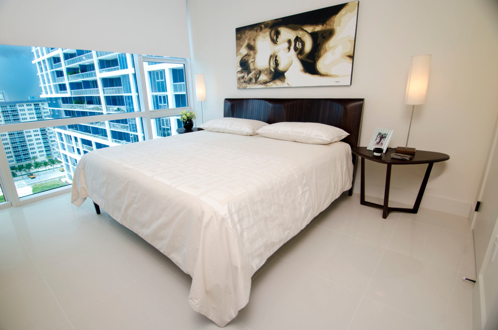 Design ideas for a mid-sized contemporary guest bedroom in Miami with beige walls and porcelain floors.