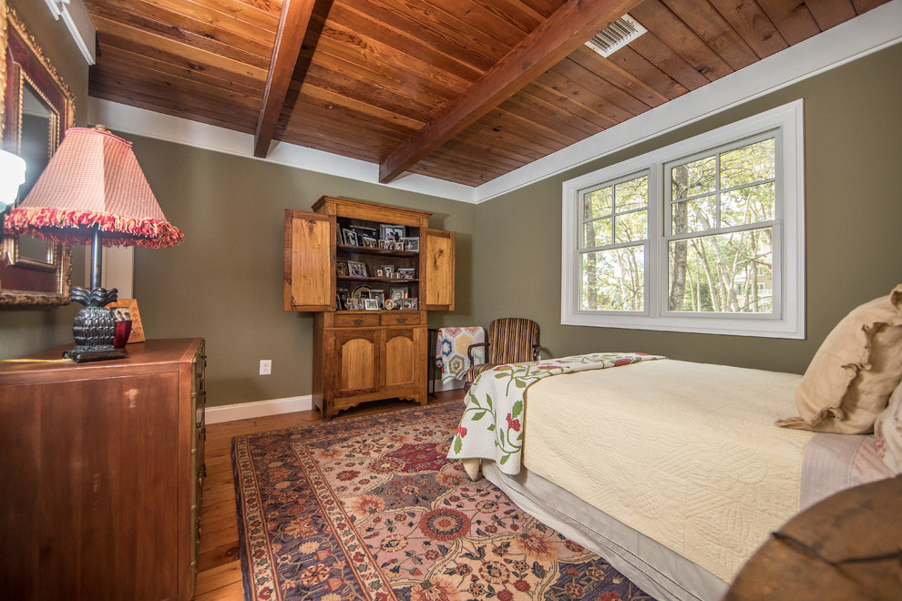 Mid-sized country master bedroom in DC Metro with beige walls, medium hardwood floors, no fireplace and brown floor.