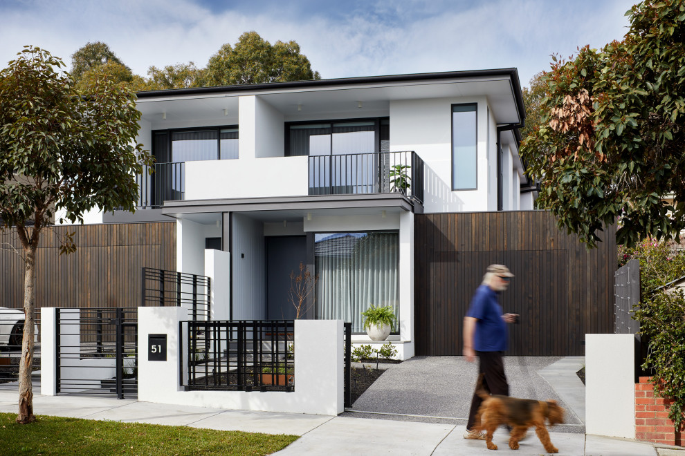 Photo of a contemporary two-storey white house exterior in Melbourne with a flat roof.