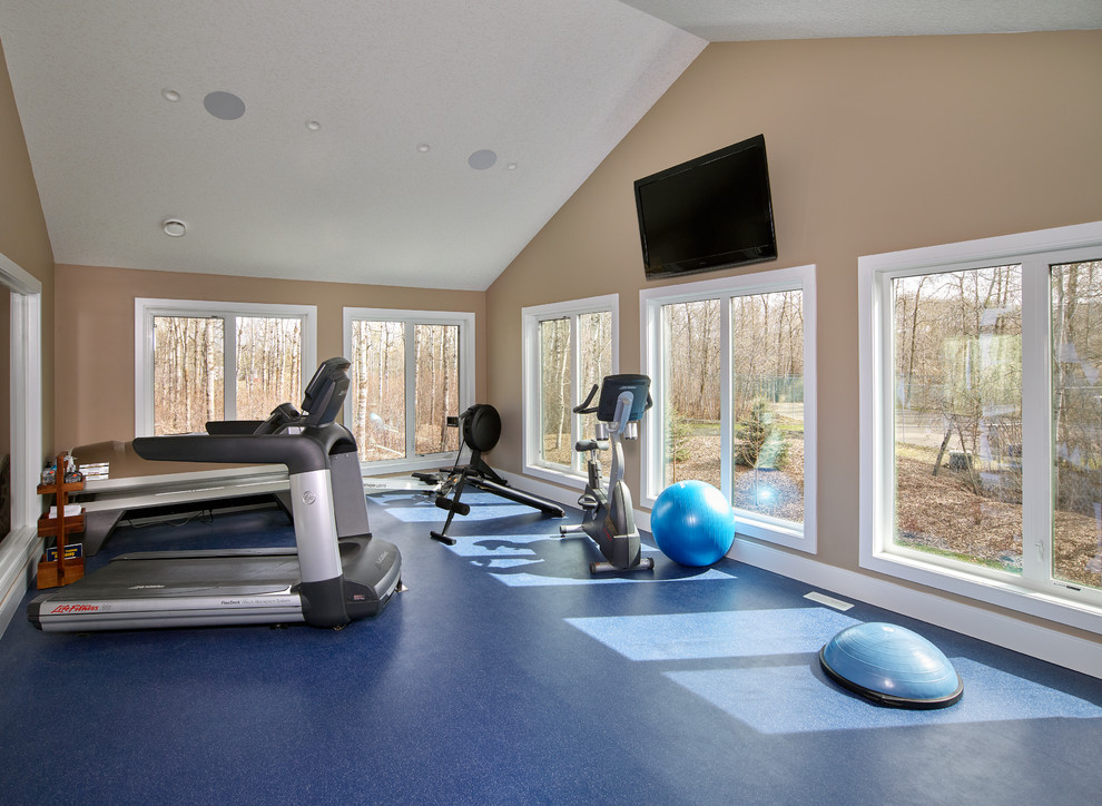 Inspiration for a mid-sized transitional multipurpose gym in Edmonton with beige walls and linoleum floors.