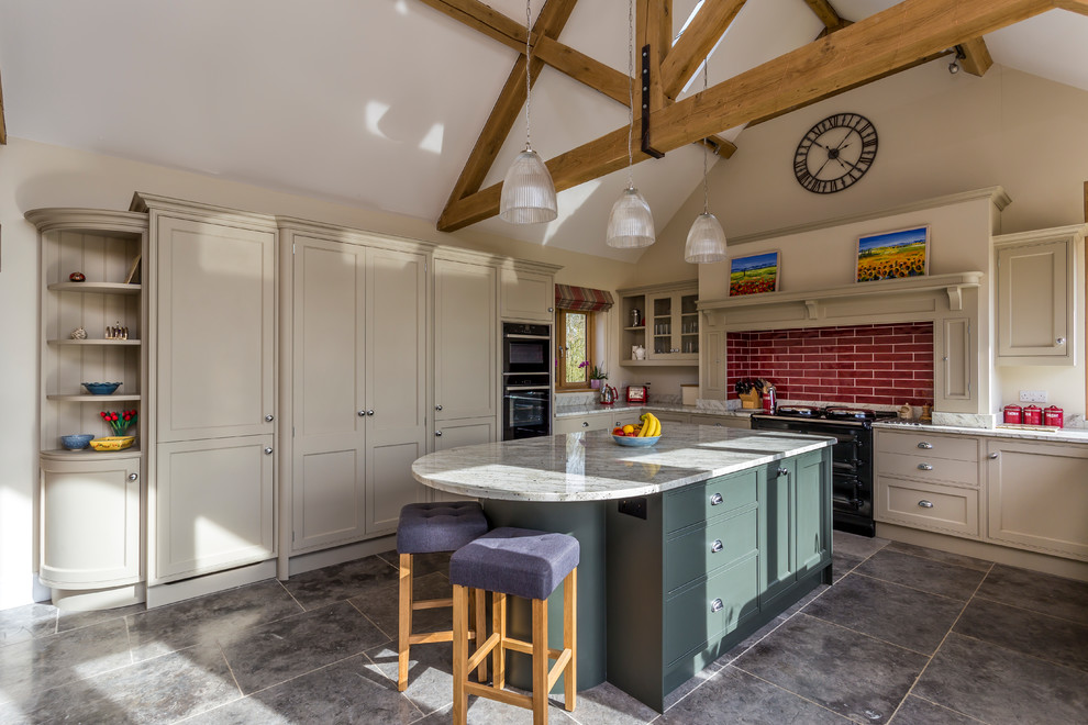 Large country l-shaped kitchen in Hertfordshire with recessed-panel cabinets, red splashback, subway tile splashback, with island, grey floor and grey benchtop.
