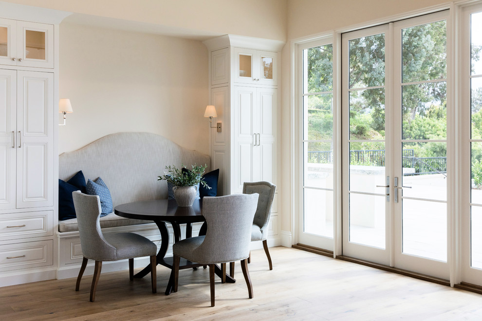 This is an example of a mid-sized transitional open plan dining in San Diego with beige walls and medium hardwood floors.