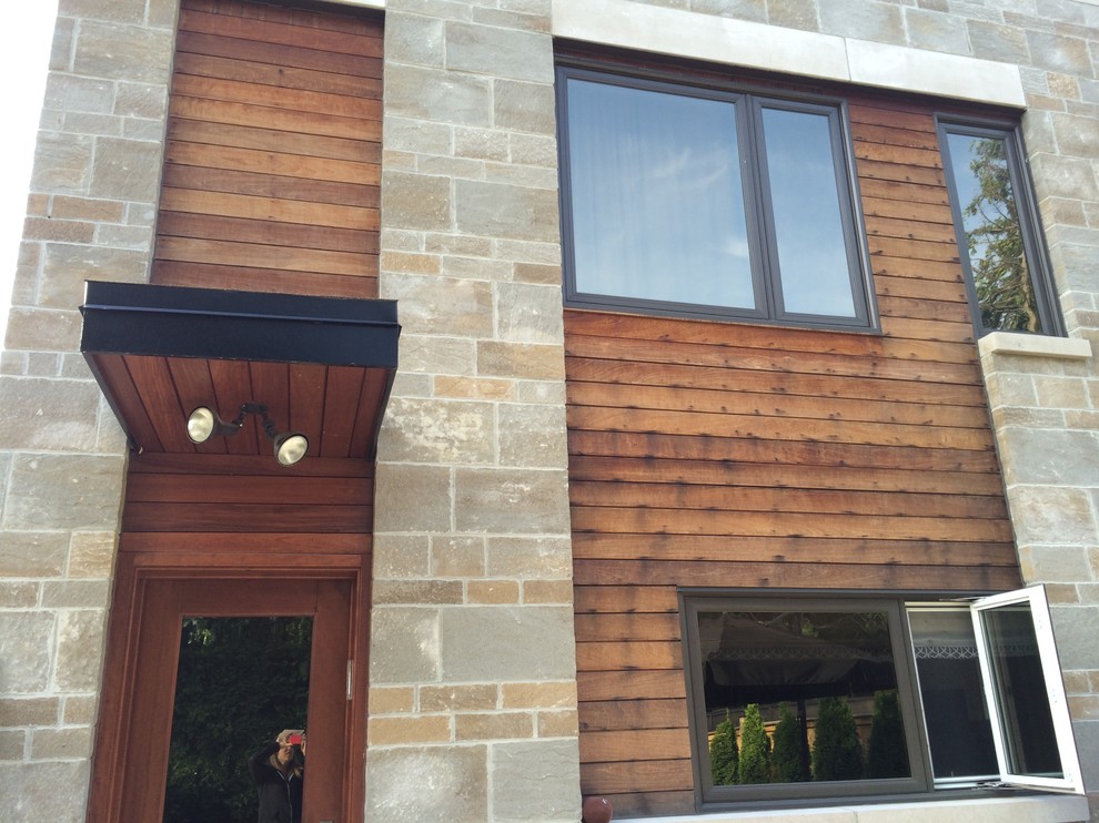 Mid-sized modern two-storey brown exterior in Toronto with wood siding.