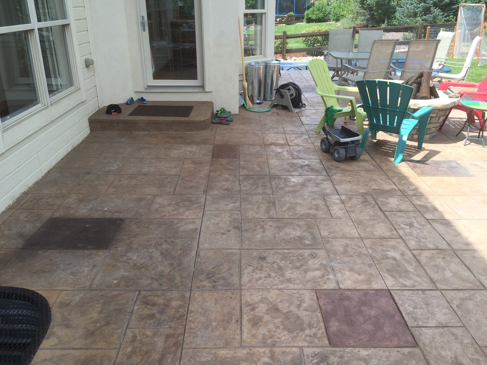 Design ideas for a large contemporary backyard patio in Denver with stamped concrete and no cover.