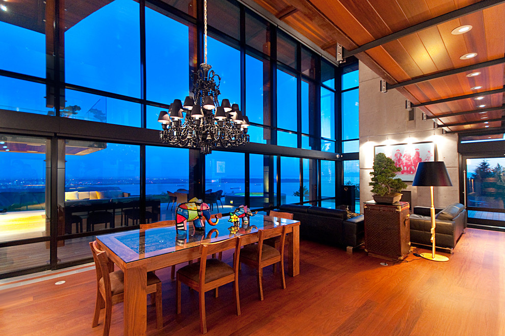 Photo of a contemporary open plan dining in Vancouver with dark hardwood floors.