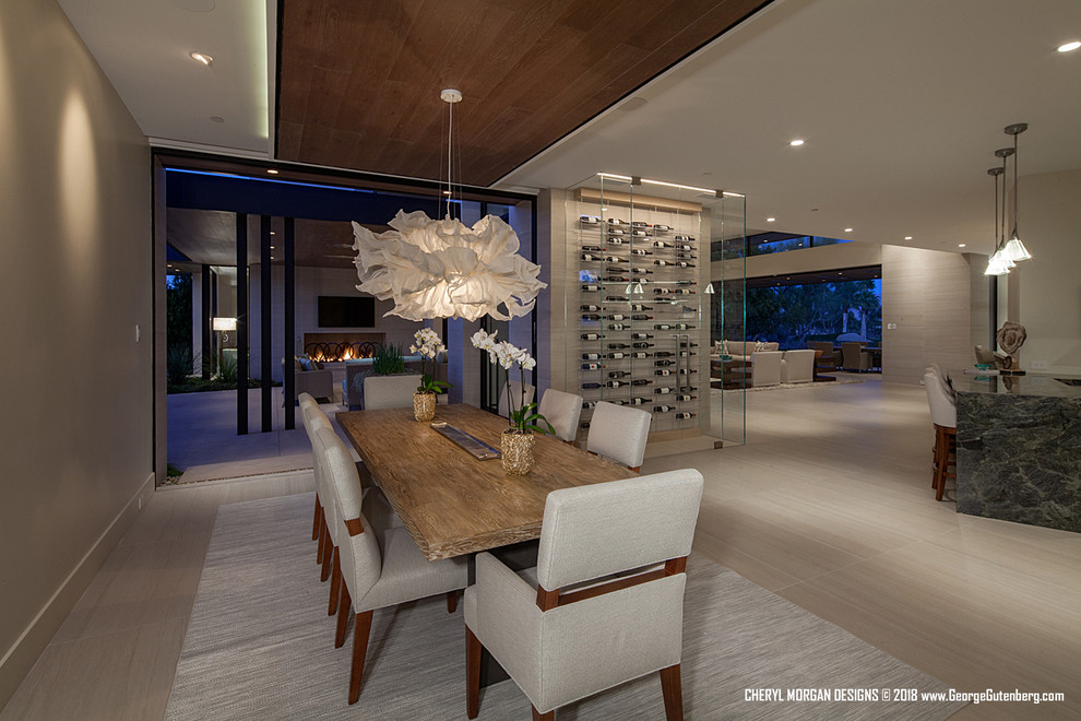 Photo of an expansive contemporary kitchen/dining combo in Los Angeles with beige walls, porcelain floors, no fireplace and beige floor.