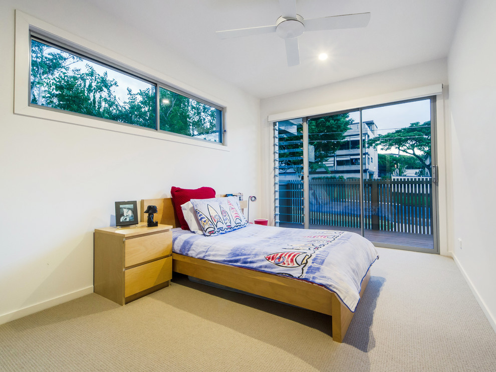 Photo of a small contemporary kids' room for boys in Brisbane with white walls, carpet and beige floor.