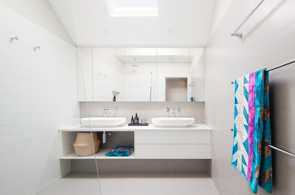 Design ideas for a small contemporary 3/4 bathroom in Melbourne with glass-front cabinets, white cabinets, an open shower, white tile, a vessel sink, laminate benchtops and an open shower.