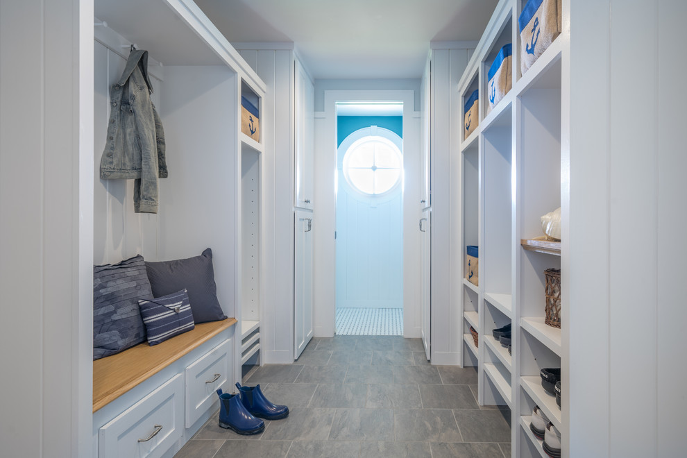 Design ideas for a mid-sized beach style mudroom in Boston with blue walls and porcelain floors.