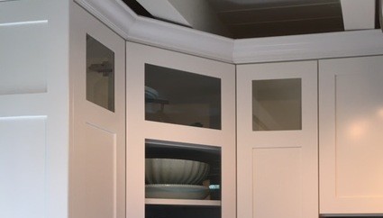 Eat-in kitchen - small transitional u-shaped light wood floor eat-in kitchen idea in Boston with recessed-panel cabinets, white cabinets and subway tile backsplash