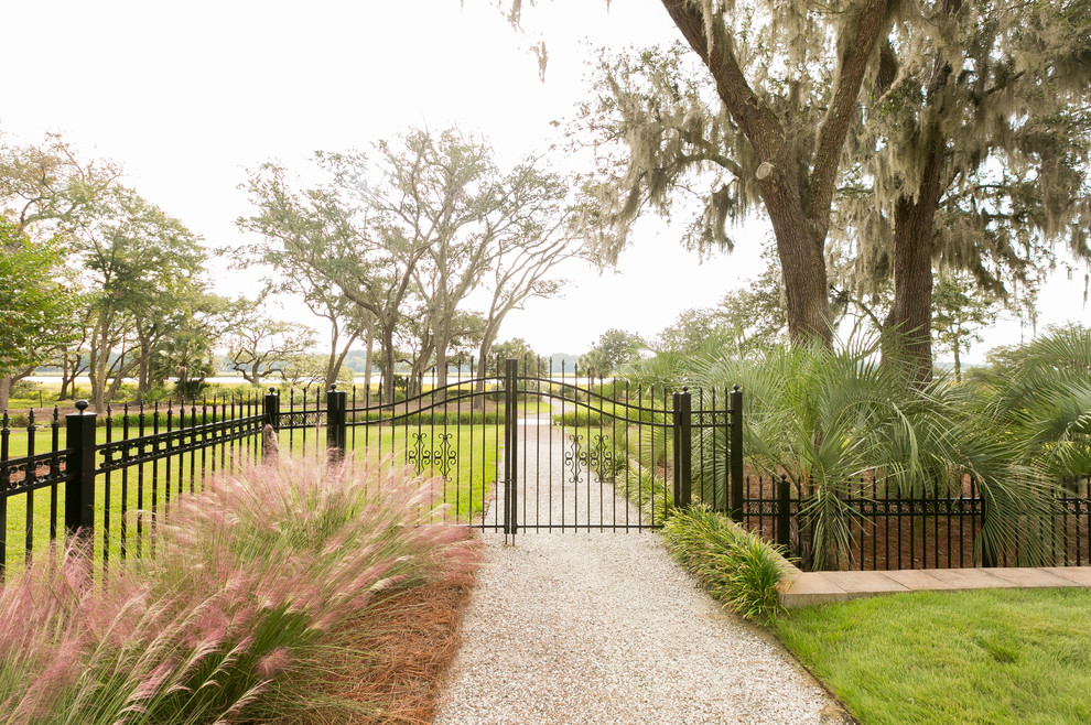 This is an example of an expansive traditional backyard full sun garden in Charleston with a garden path and gravel.