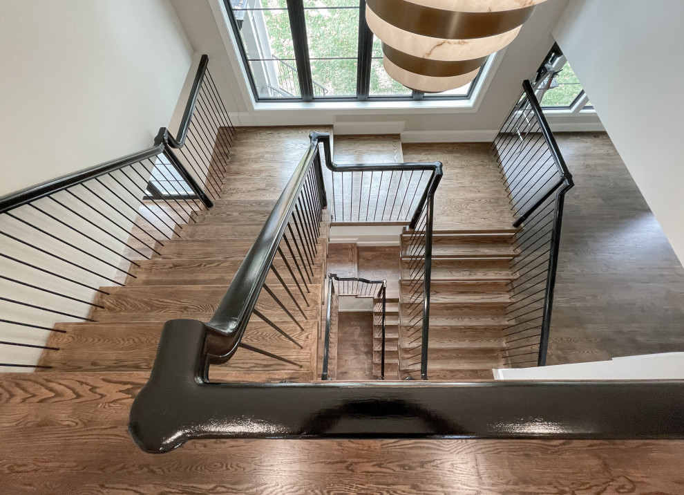Inspiration for an expansive eclectic wood u-shaped mixed railing staircase in DC Metro with wood risers.