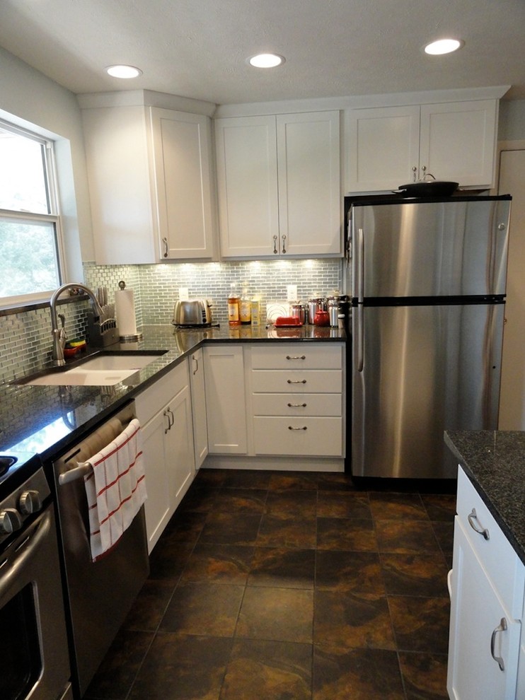 Eat-in kitchen - mid-sized transitional l-shaped vinyl floor and brown floor eat-in kitchen idea in Denver with a double-bowl sink, recessed-panel cabinets, white cabinets, stainless steel appliances, an island, granite countertops, metallic backsplash and metal backsplash