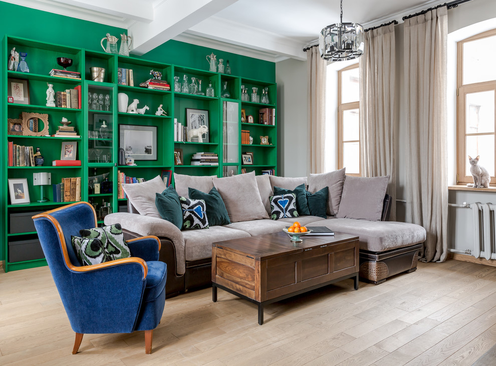 Eclectic living room in Moscow with green walls, light hardwood floors and beige floor.