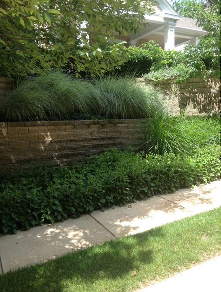 Design ideas for a large shade backyard stone retaining wall landscape.