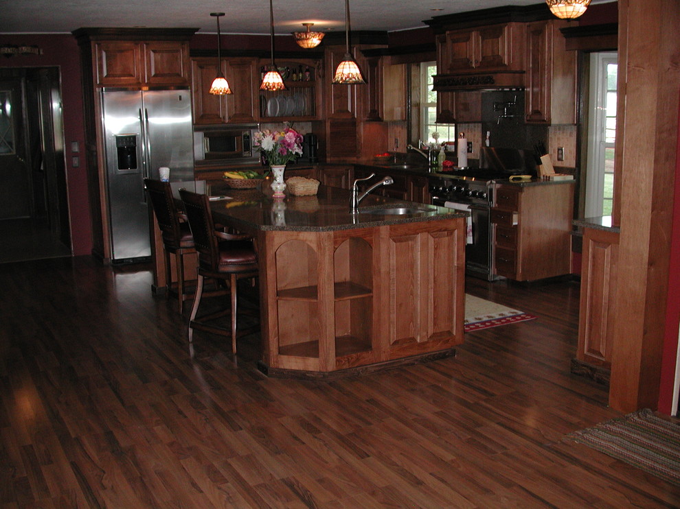 This is an example of a traditional l-shaped eat-in kitchen in Other.