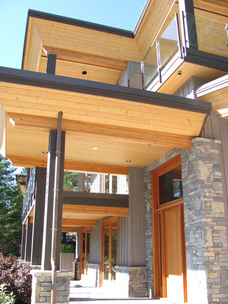 Front door - rustic front door idea in Vancouver with a light wood front door