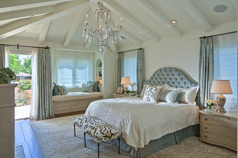 Traditional bedroom in Los Angeles with white walls, medium hardwood floors and brown floor.