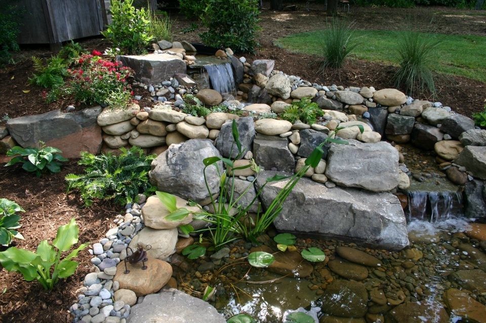 Mid-sized backyard garden in Charlotte with a water feature and natural stone pavers.
