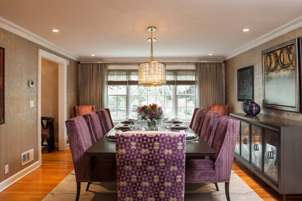 This is an example of a transitional dining room in Chicago with medium hardwood floors and metallic walls.