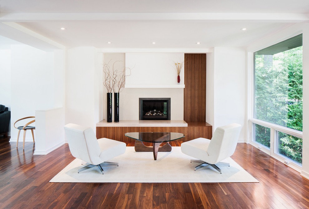 Inspiration for a contemporary open concept family room in Ottawa with white walls, dark hardwood floors and a standard fireplace.