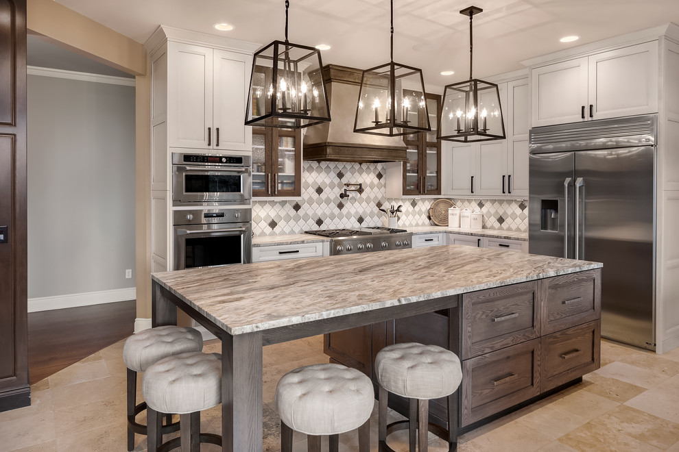 Inspiration for an expansive transitional l-shaped eat-in kitchen in Seattle with quartzite benchtops, porcelain splashback, stainless steel appliances, limestone floors, with island, recessed-panel cabinets, medium wood cabinets, multi-coloured splashback, beige floor and grey benchtop.