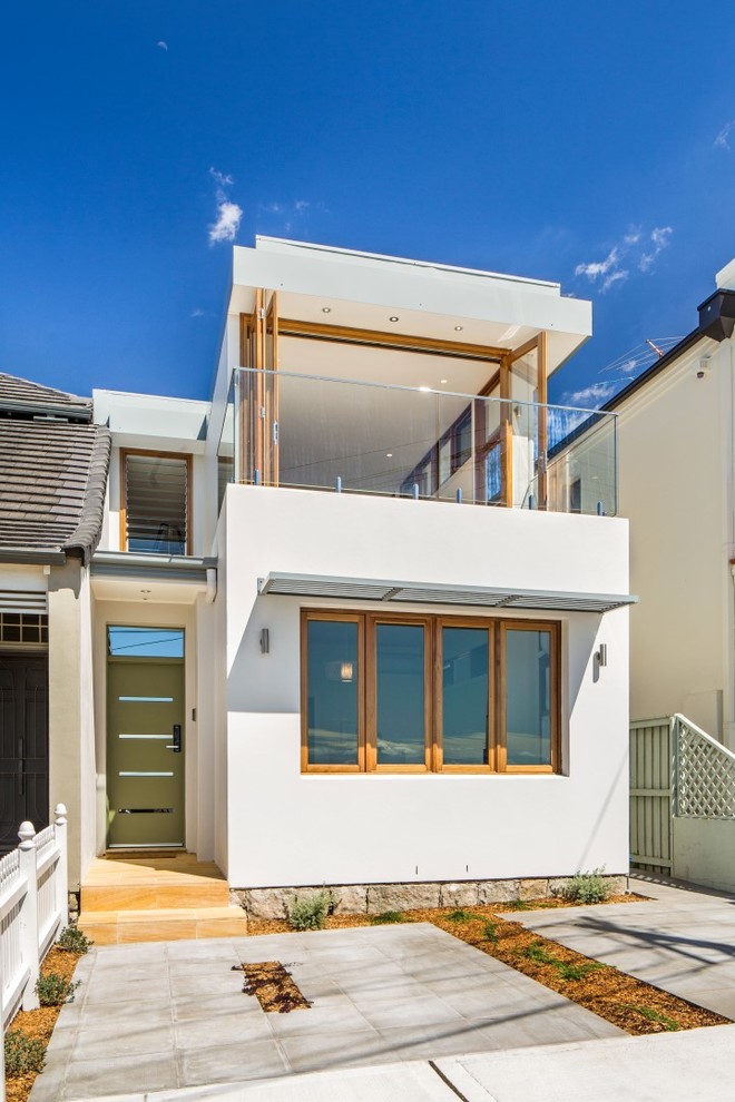 Photo of a mid-sized contemporary two-storey concrete white exterior in Sydney with a flat roof.