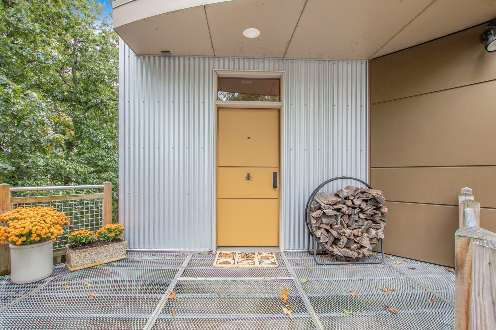 Example of a mountain style front door design in Grand Rapids with a yellow front door