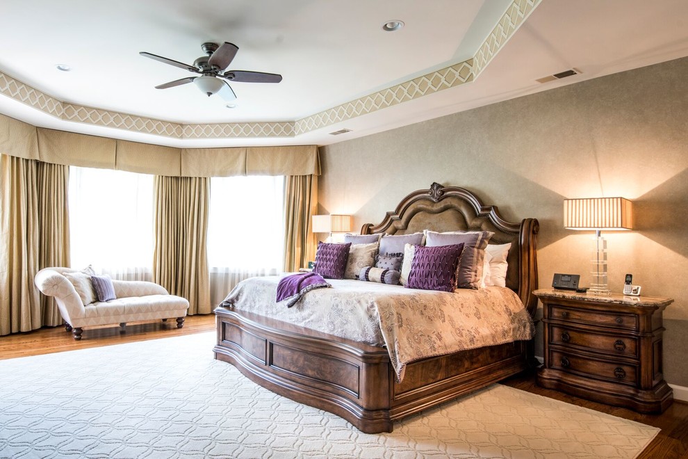 Large traditional master bedroom in DC Metro with beige walls, medium hardwood floors and no fireplace.