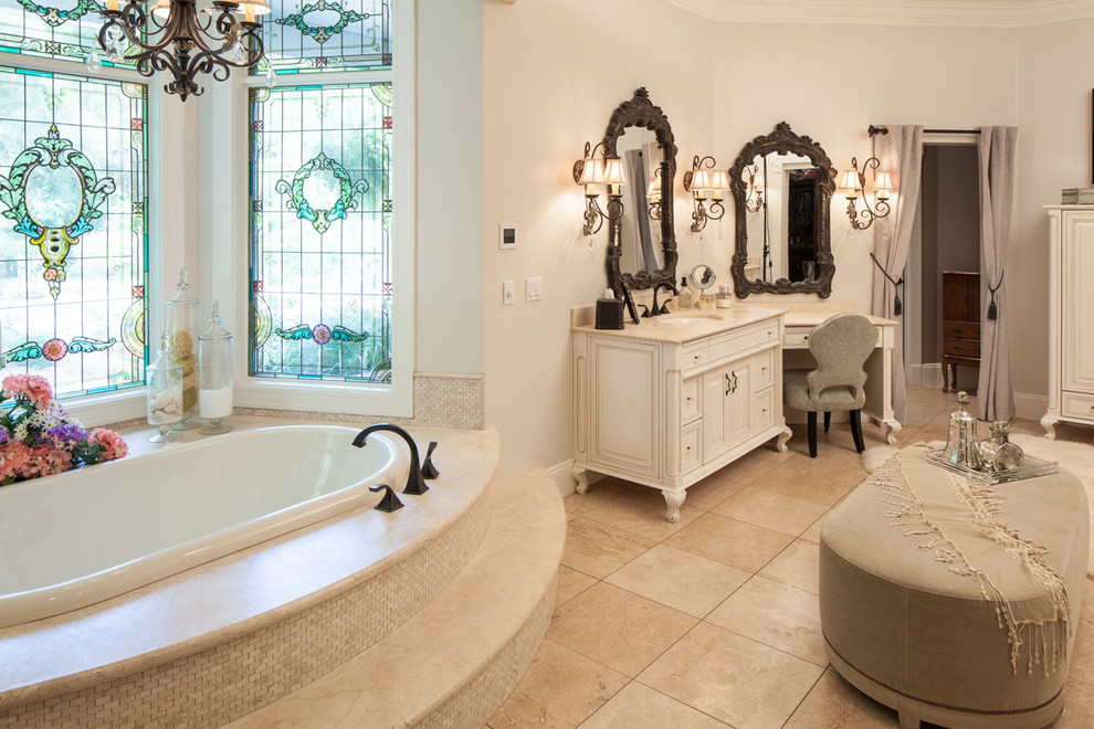 Design ideas for a mid-sized transitional master bathroom in Other with glass-front cabinets, beige cabinets, medium hardwood floors, a drop-in tub, an alcove shower, beige tile, porcelain tile, black walls, an undermount sink and glass benchtops.
