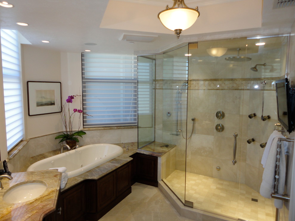 Large bathroom in Tampa with furniture-like cabinets, dark wood cabinets, granite benchtops, beige tile, stone tile, a drop-in tub, beige walls, marble floors and with a sauna.
