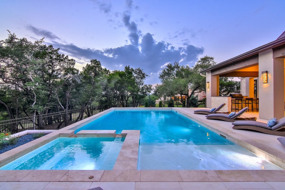 Design ideas for a mid-sized transitional backyard rectangular infinity pool in Austin with a hot tub and concrete pavers.