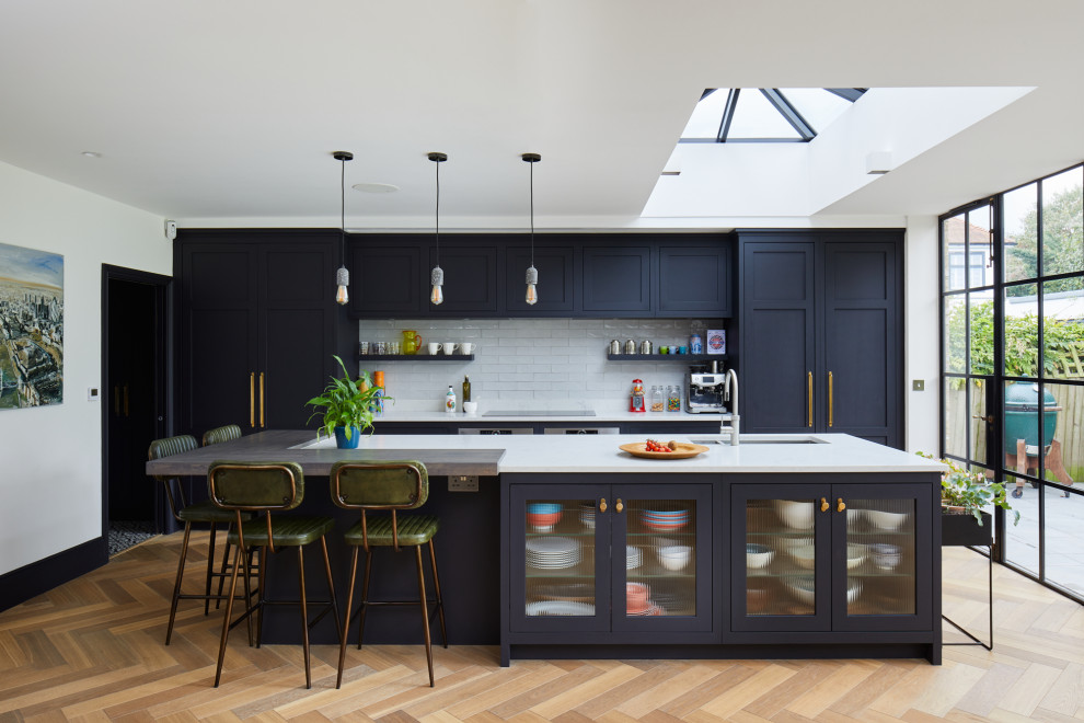 Inspiration for a large transitional open plan kitchen in London with with island.