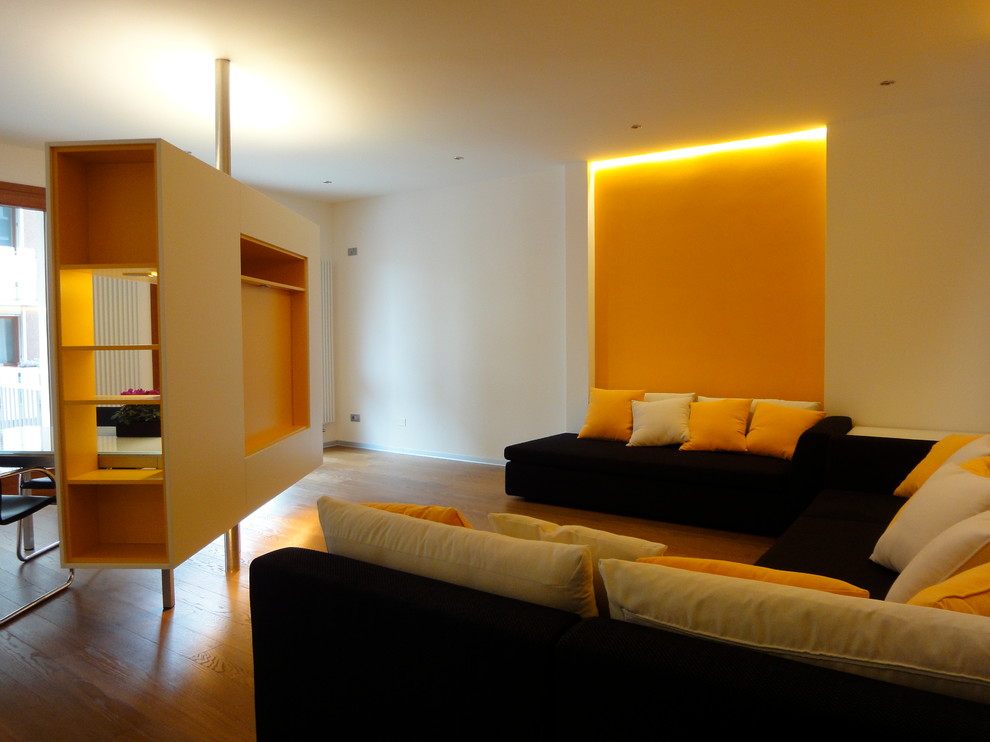 Inspiration for a contemporary living room in Venice with orange walls, painted wood floors and a built-in media wall.