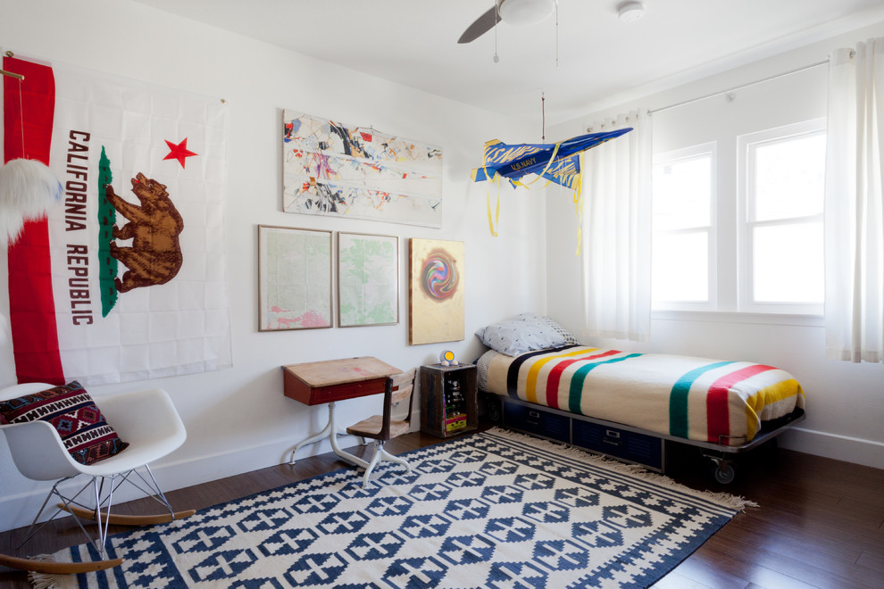 This is an example of an eclectic gender-neutral kids' room in Los Angeles with yellow walls and dark hardwood floors.