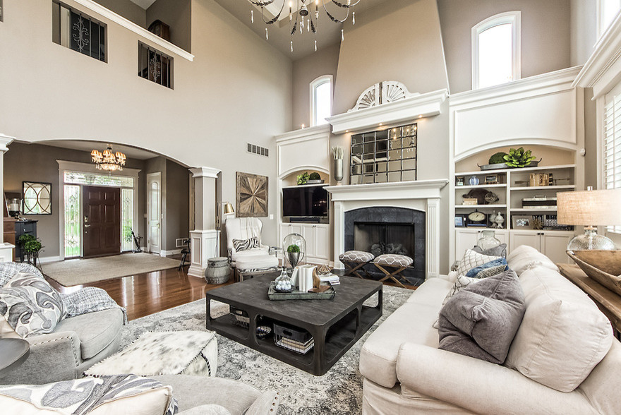Mid-sized transitional open concept medium tone wood floor living room photo in Columbus with beige walls, a standard fireplace, a tile fireplace and a media wall