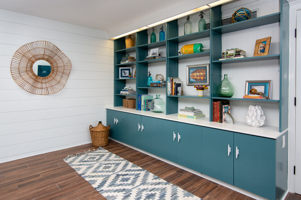 Mid-sized beach style walk-out ceramic tile, brown floor and wall paneling basement game room photo in Baltimore with multicolored walls, a corner fireplace and a stacked stone fireplace