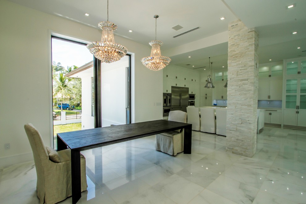 Large modern open plan dining in Miami with white walls, marble floors, no fireplace and white floor.