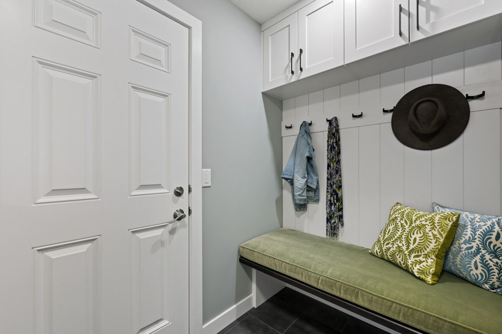 Design ideas for a mid-sized contemporary mudroom in Calgary with grey walls, ceramic floors, a single front door, a white front door and grey floor.