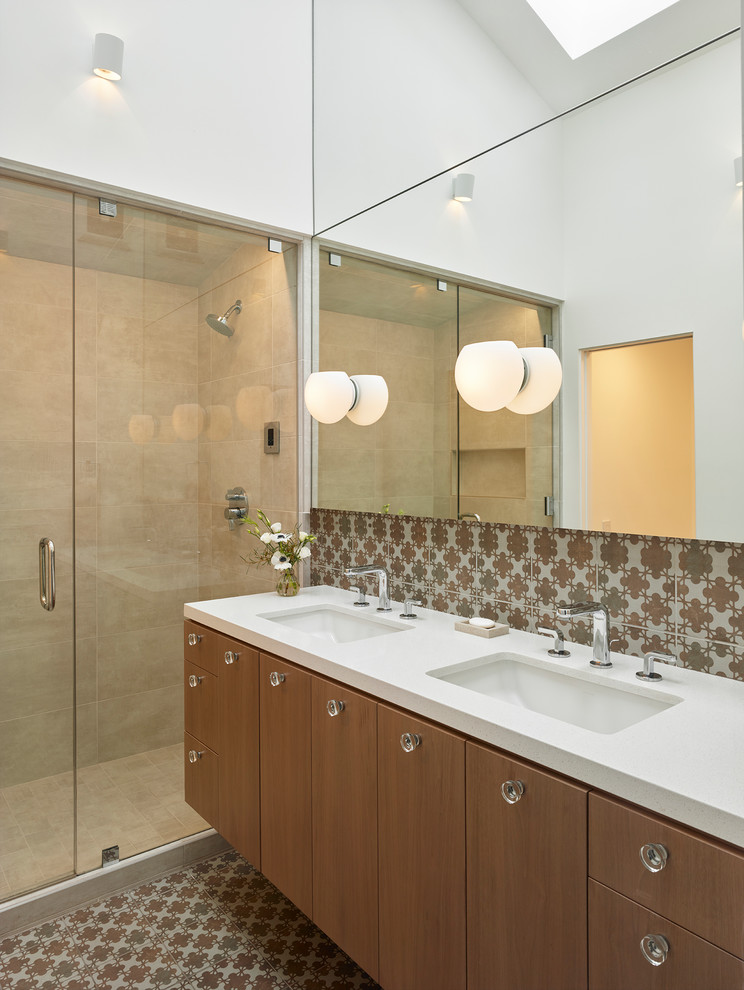 This is an example of a small contemporary master bathroom in Los Angeles with flat-panel cabinets, medium wood cabinets, an alcove shower, a one-piece toilet, multi-coloured tile, porcelain tile, white walls, porcelain floors, an undermount sink, engineered quartz benchtops, multi-coloured floor and a hinged shower door.