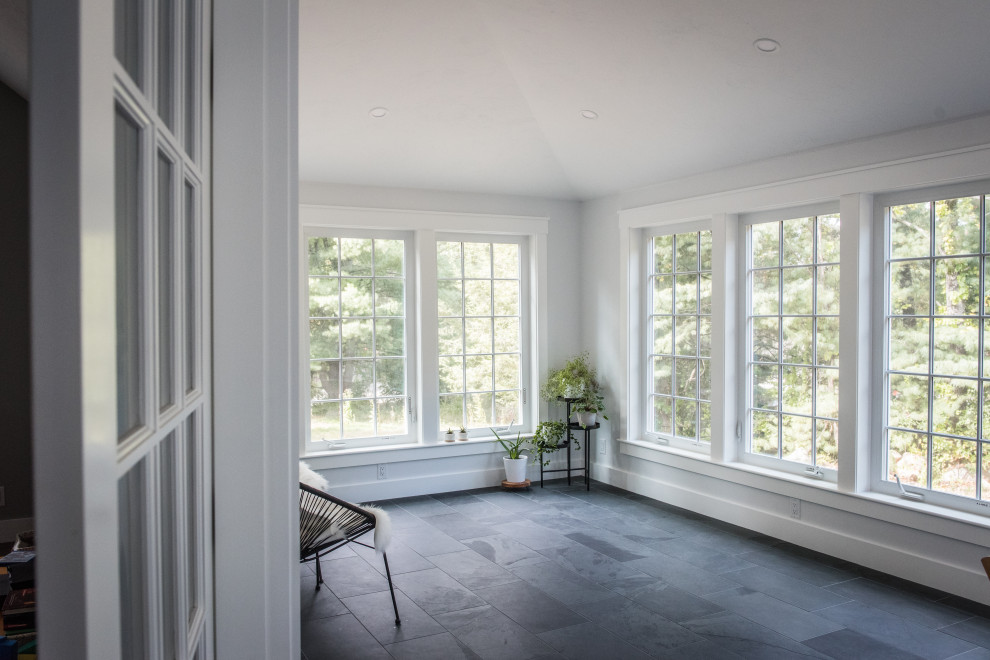 This is an example of a mid-sized traditional sunroom in Boston with slate floors, a standard ceiling and grey floor.